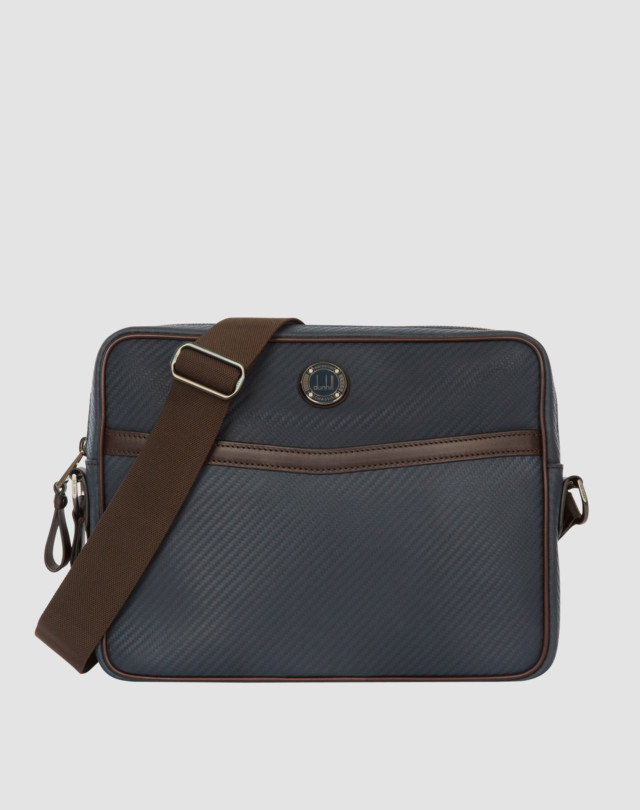 Bag is shown in navy with brown leather trim