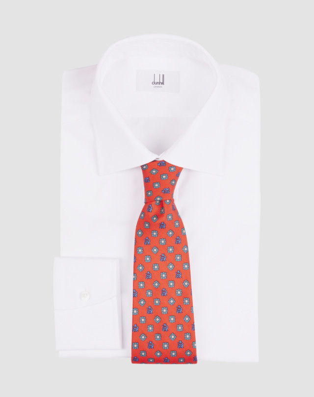 Tie is shown in navy with light blue, red and pale yellow floral and logo print